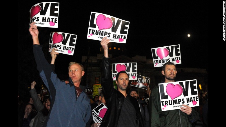 Protesters advertising the love trumps hate (image via cnn.com) 