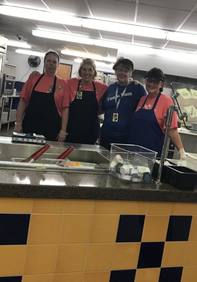 Lunch ladies proudly display new additions.