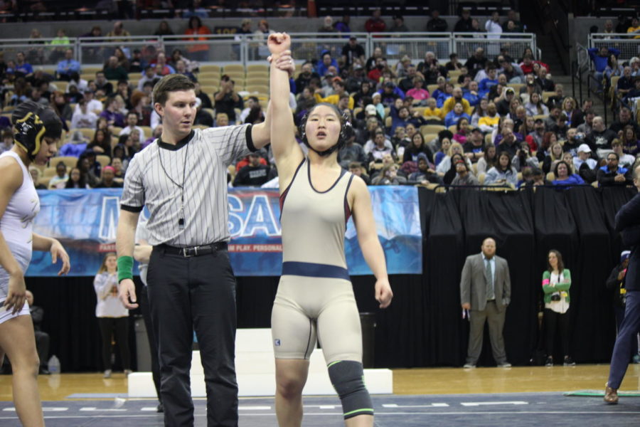 Esther Han (22) takes home the gold at the Wrestling State Tournament.