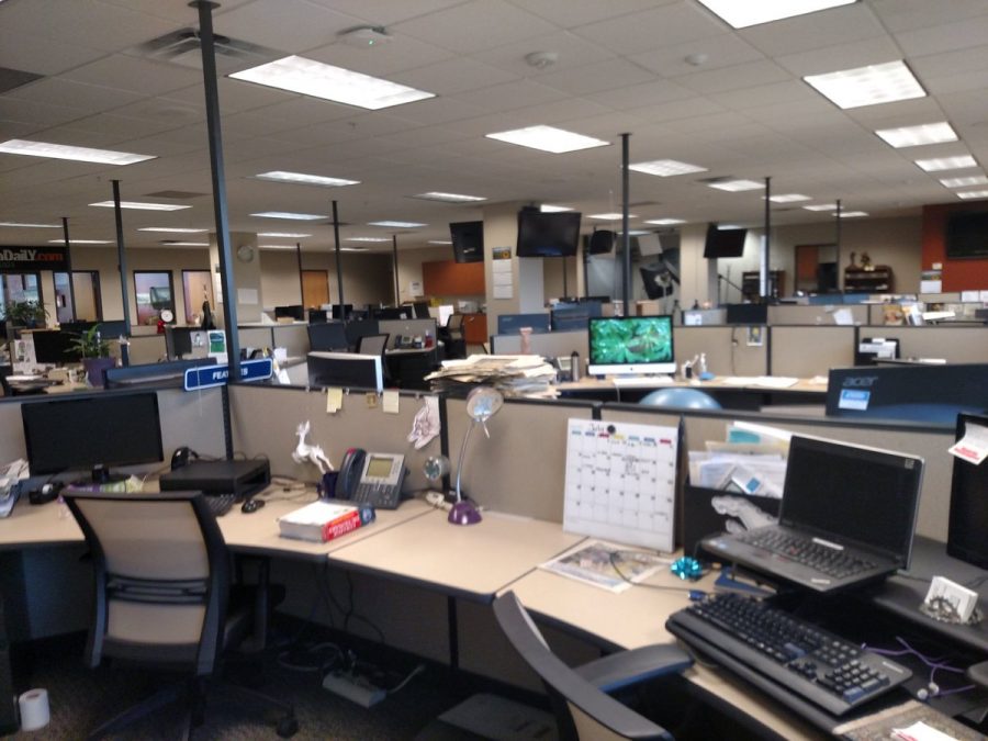 Photo of a near empty newsroom similar to many currently. 
