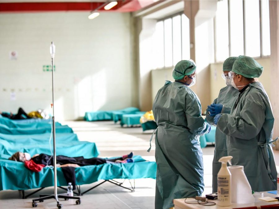 Healthcare professionals work in one of the emergency structures to easily take care of the many COVID-19 patients at the hospital in Brescia, Northern Italy. 
