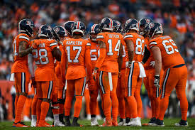 The Broncos huddle before a game.