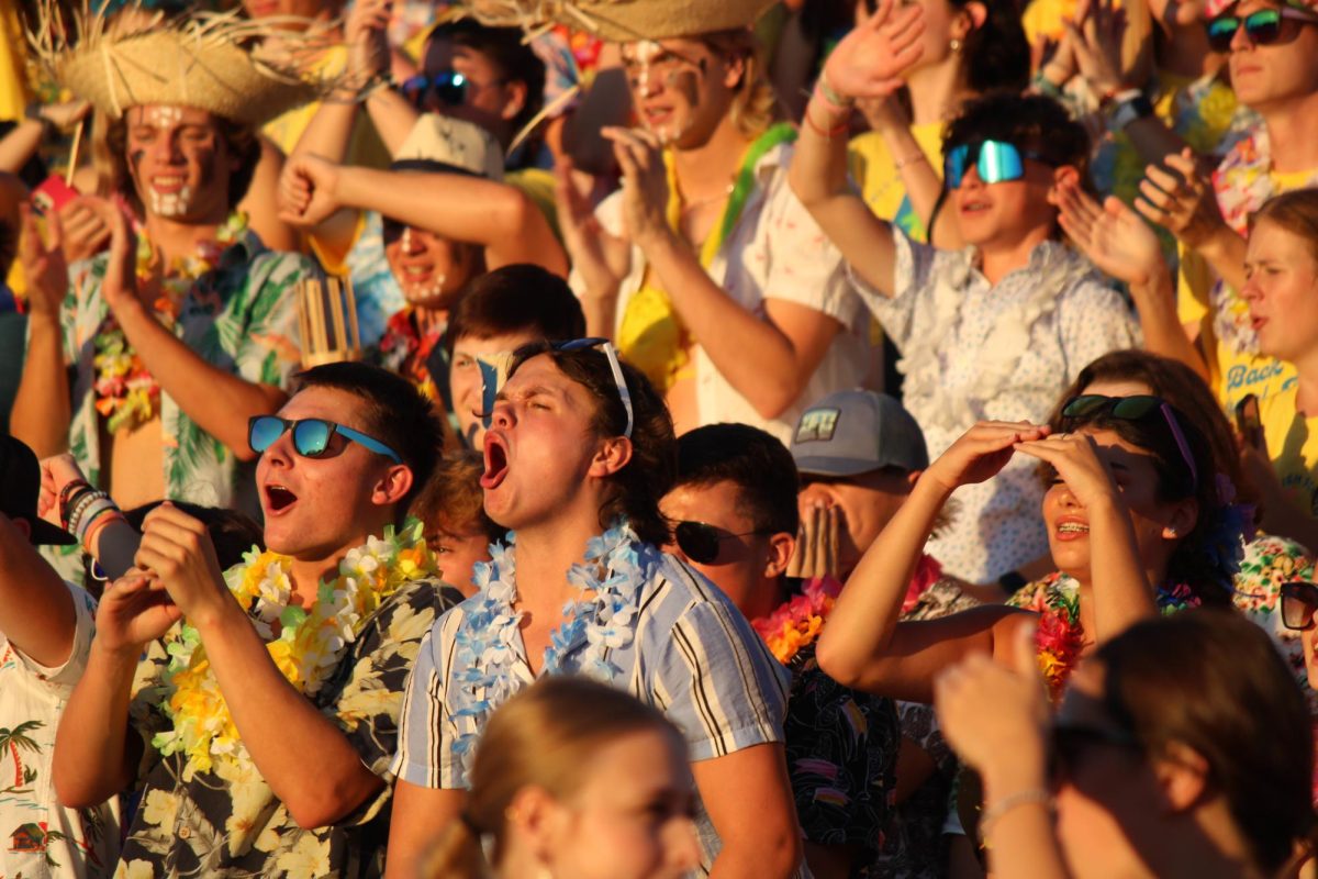 The+Student+Section+of+Soby+Field+shows+their+school+spirit+during+a+varsity+football+game+against+Liberty+High+School.+The+theme+was+Hawaiian%2C+and+many+students+wore+tropical+clothes+to+the+game.