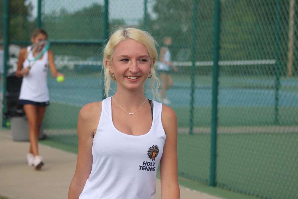 Ciara Cassady (26) shows the grin on her face as she prepares for her tennis match.