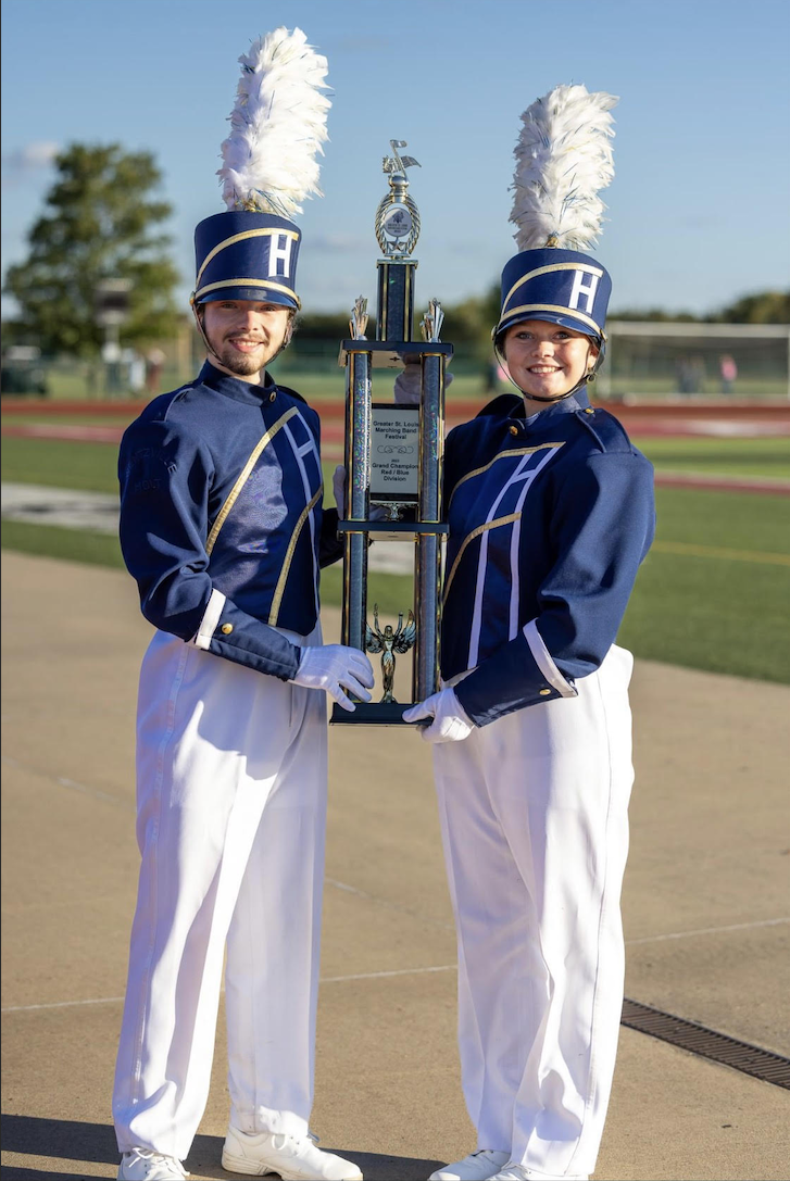 Alayna Seabaugh and Dominic Gramolino holding bands' award from the Greater St Louis Marching Band Festival