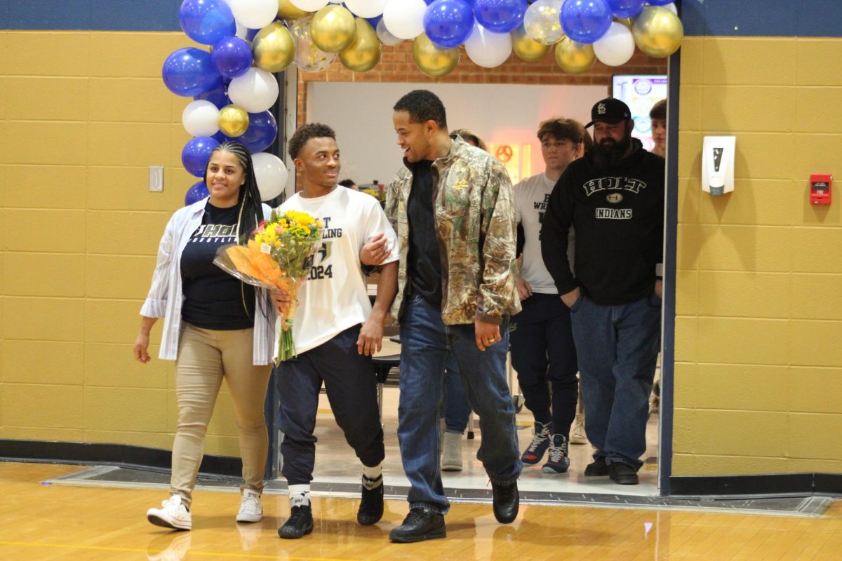 Jackie Diekman (24) walking out with his parents before his senior night match.