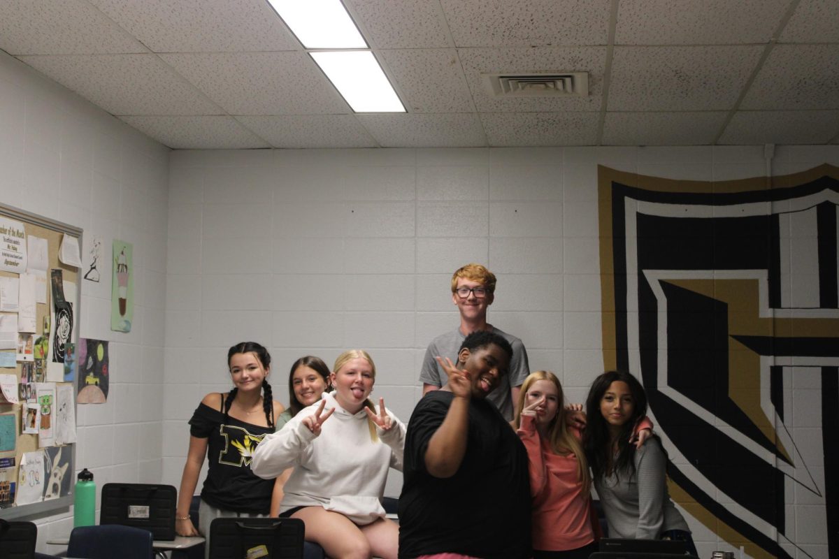 Say Cheese! A group of freshmen in History Teacher Sean Haley’s Western Civilization class pose for a picture. “I like Mr. Haley because he is very chill and relaxed, and I like the people in the class,” Lucy Corgan (‘28) said.